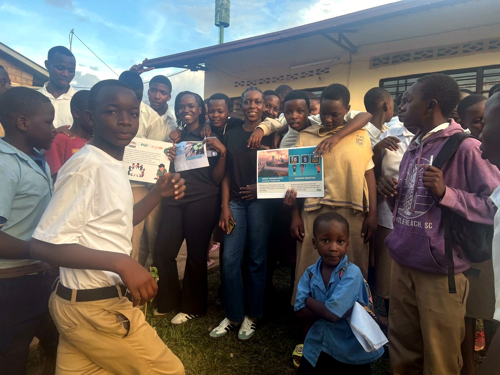 GS Rwankuba students and QS Impact Kigali Council leaders holding climate education posters during Global Day of Action 2026