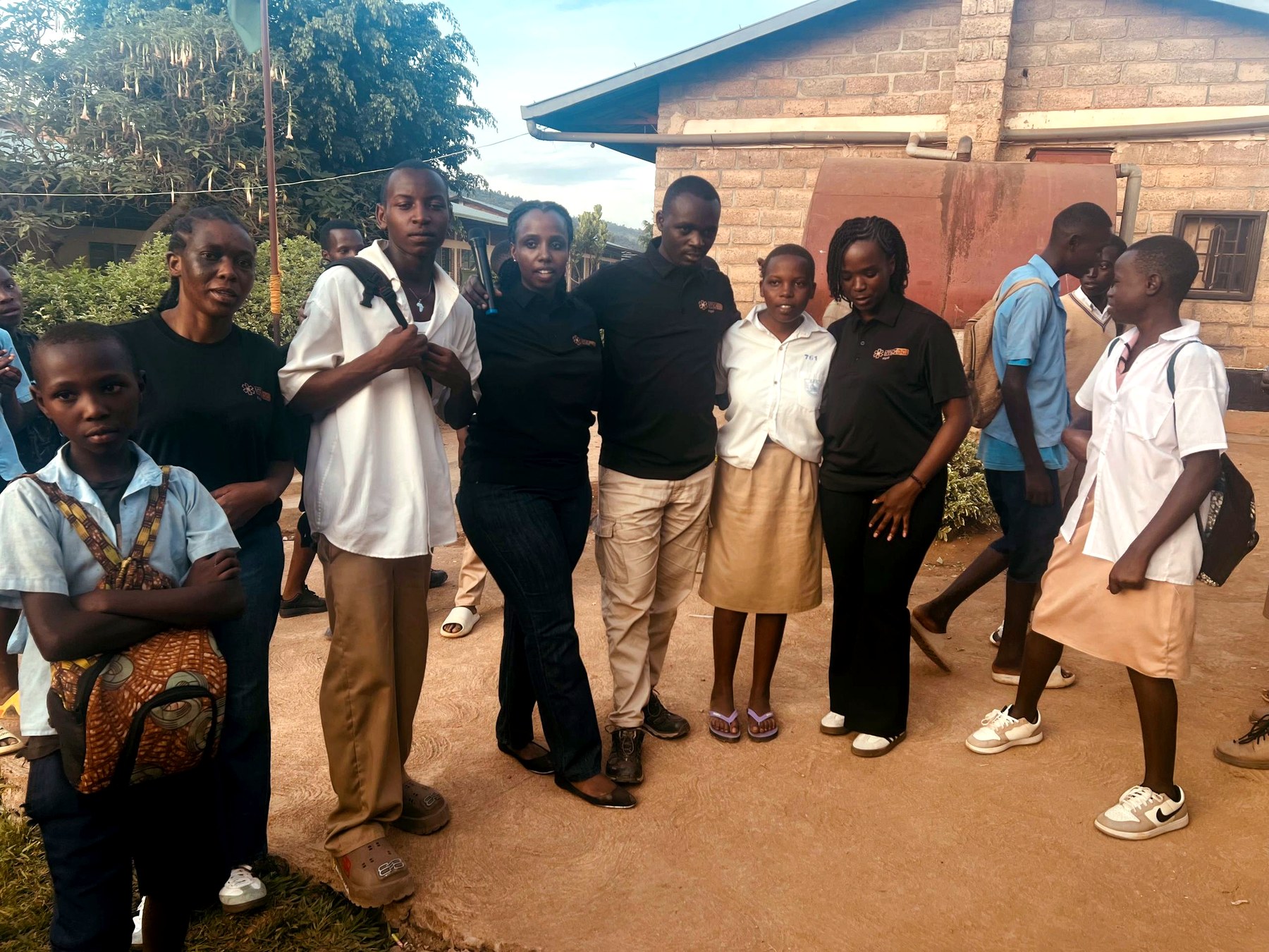 QS Impact Kigali Council members with a supported high school student